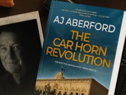 A photo of AJ Aberford & the cover of The Car Horn Revolution