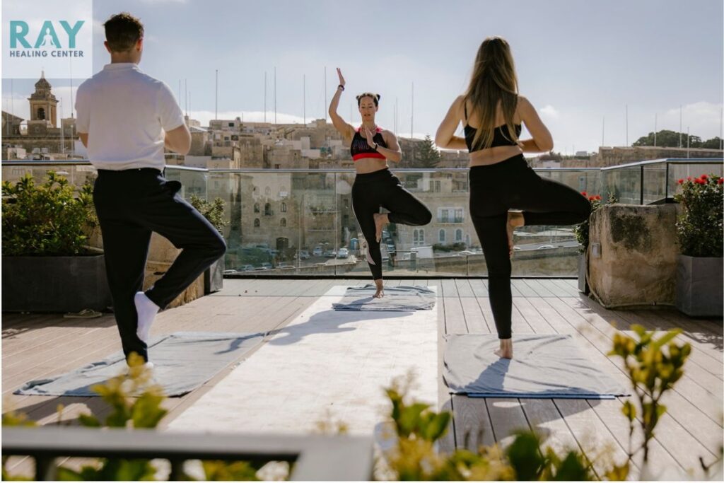 three people doing yoga