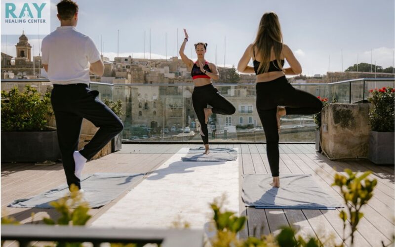 three people doing yoga