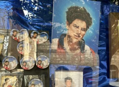 Carlo Acutis souvenirs displayed in a shop window