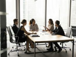 Employees in a discussion around a table