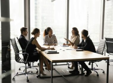 Employees in a discussion around a table