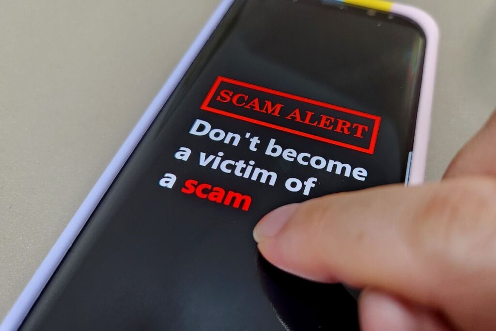 a phone screen reading SCAM ALERT