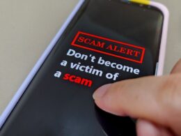 a phone screen reading SCAM ALERT