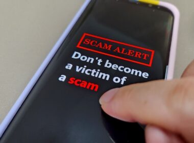 a phone screen reading SCAM ALERT