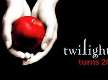 a red apple in a pair of white hands