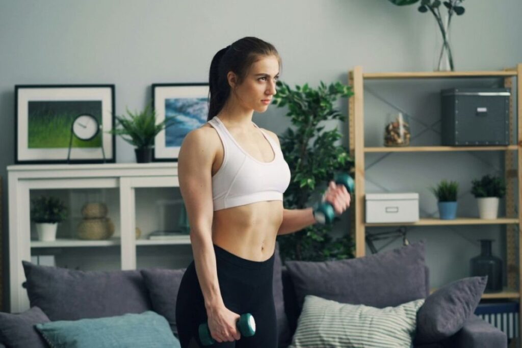 a woman in her living rooms with weights