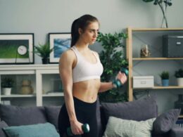 a woman in her living rooms with weights