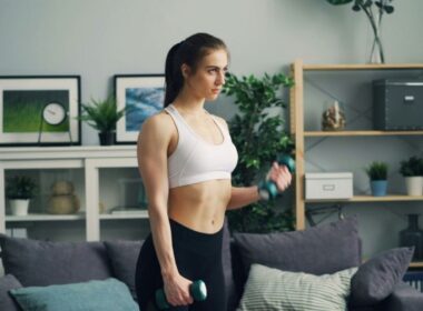a woman in her living rooms with weights