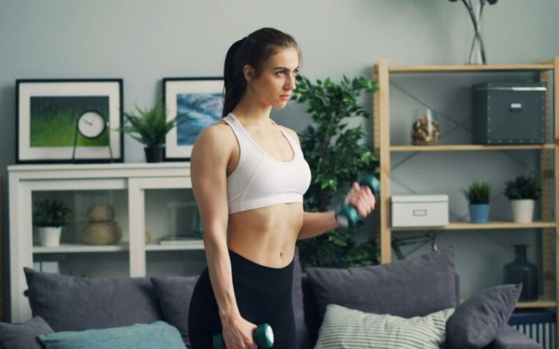 a woman in her living rooms with weights