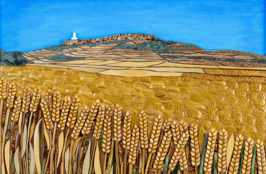 A field of wheat and a lighthouse on a hill
