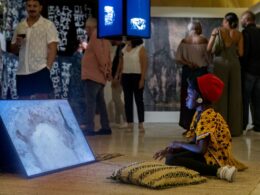 Girl watches Rural Futurisms video Building the Hut-Lab in Makgobistad. Photo by Elisa von Brockdorff