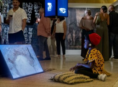 Girl watches Rural Futurisms video Building the Hut-Lab in Makgobistad. Photo by Elisa von Brockdorff