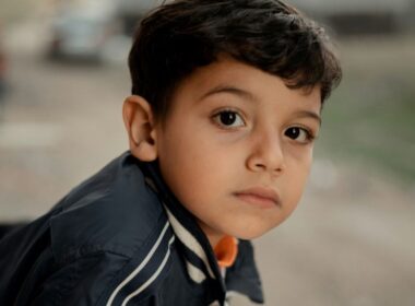 A young boy looks pensive