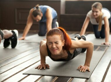 A woman grimacing in an exercise class
