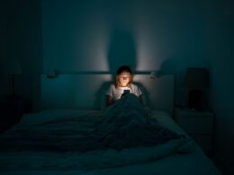 a woman on her phone in bed