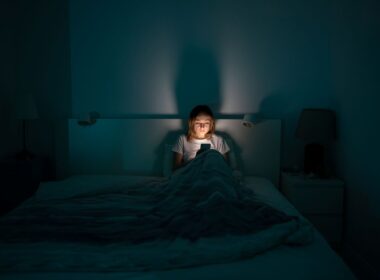 a woman on her phone in bed